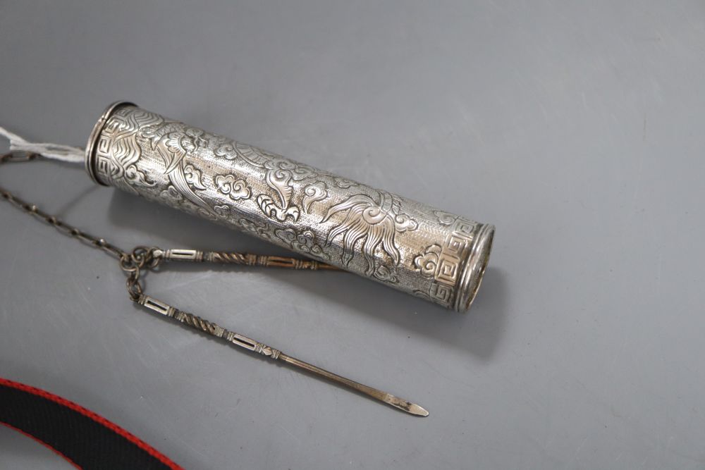 An early 20th century Middle Eastern repousse white metal incense case, 11.2cm, with two implements on a chain, gross 53 grams.